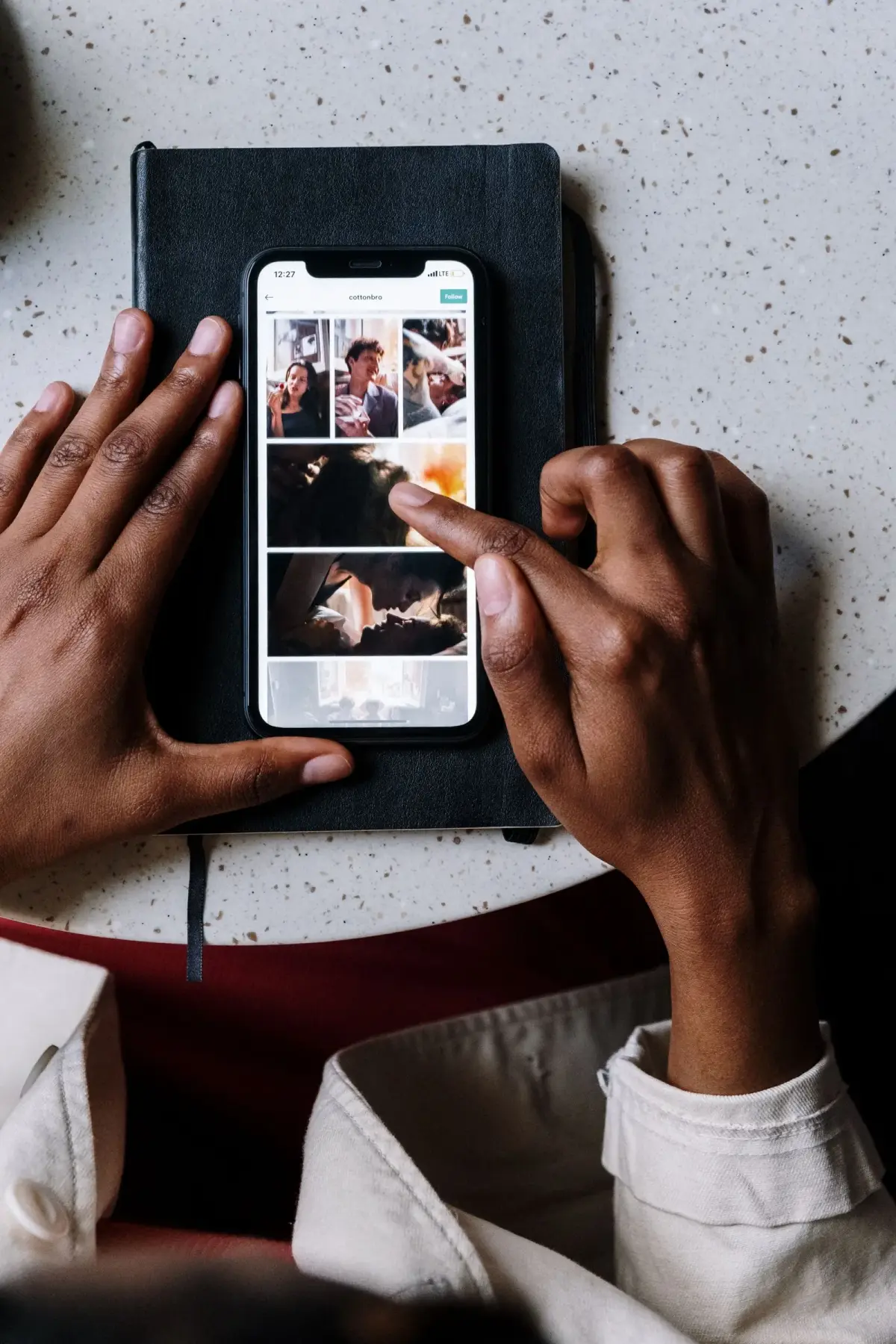 A thumb over a phone feed